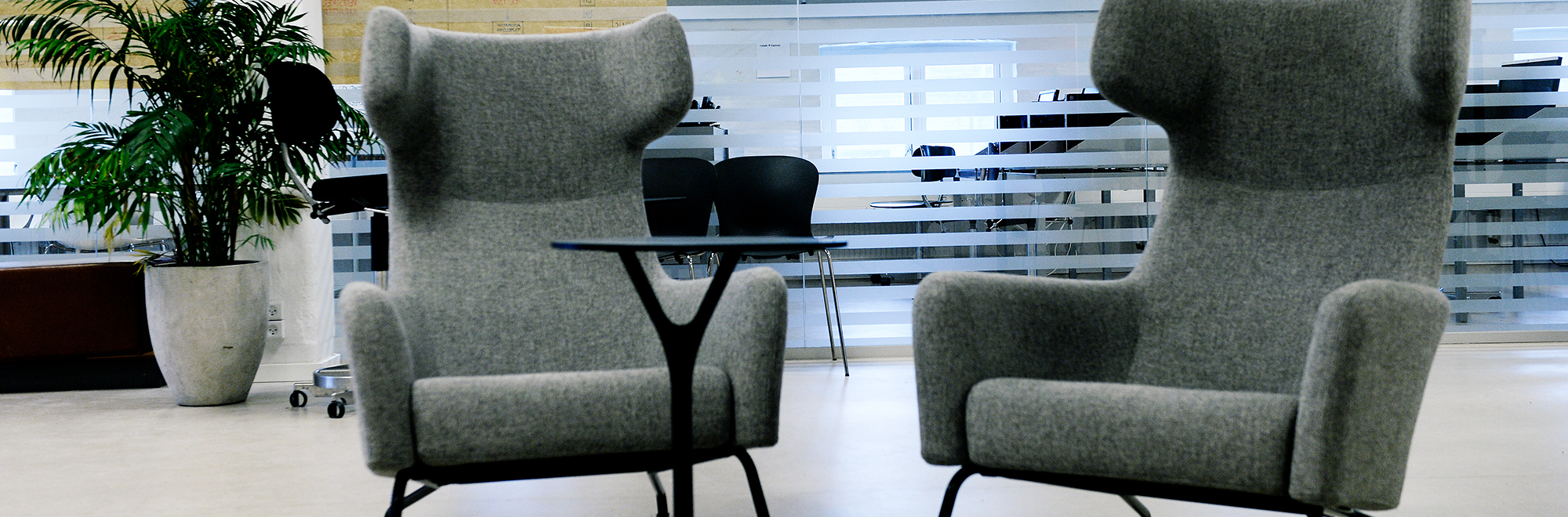 Porcelænshaven indefra med lænestole og et lille bord